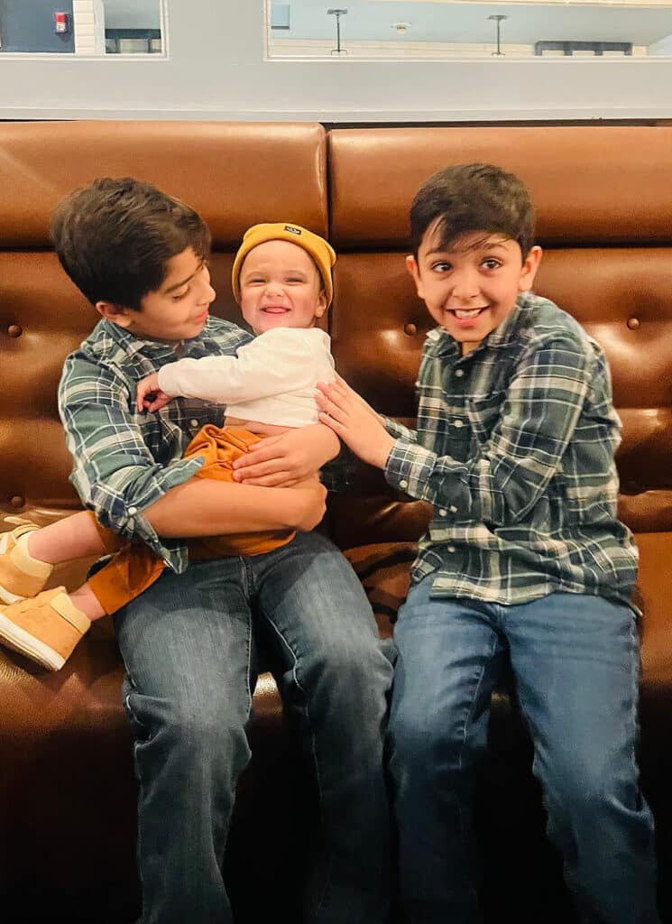 comprehend the mind 2 young boys smiling with 1 baby child smiling