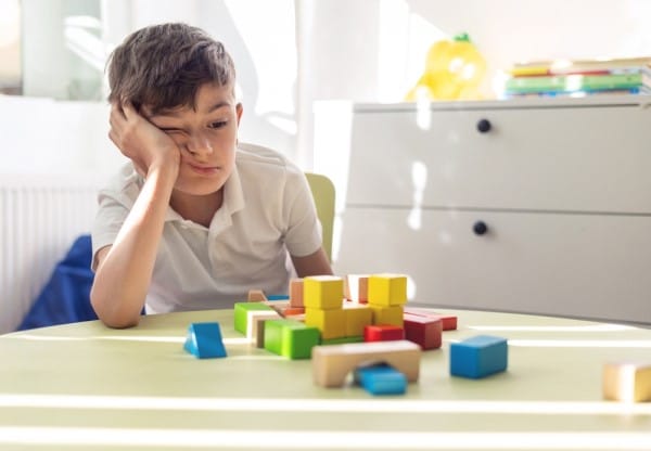 Developmental Delays in New York Resting his Head on One Hand and Looking Bored