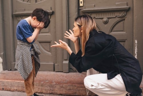Mom scolding her child for behavioral issues